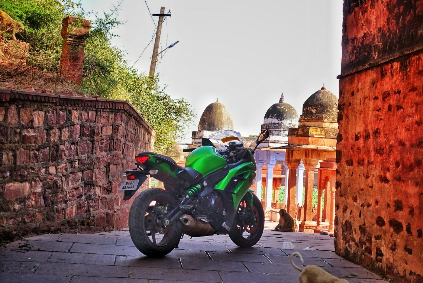 A motorcycle photographed near historic architecture around Gwalior