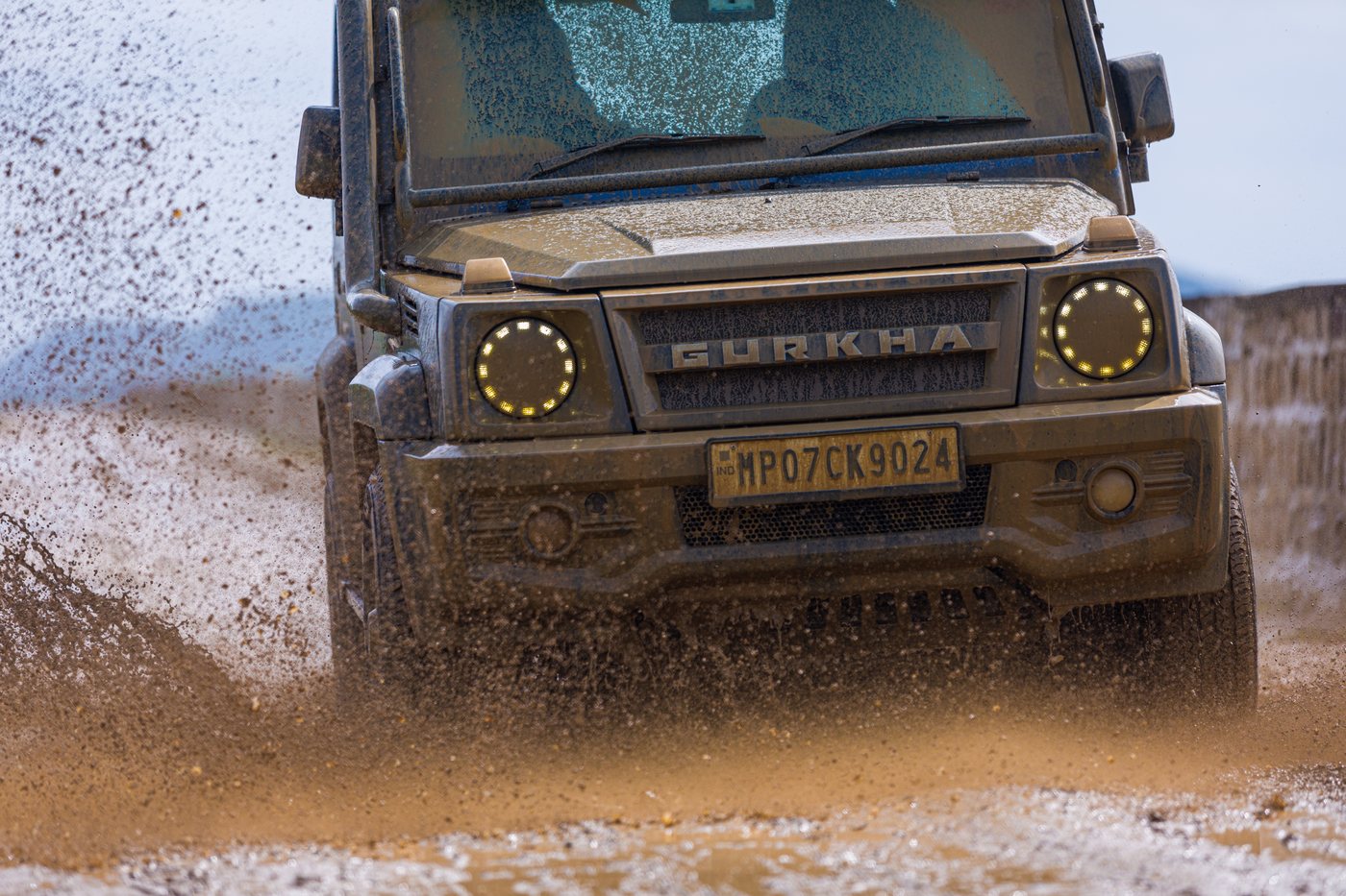 A Force Gurkha driving through water during an off-road trail