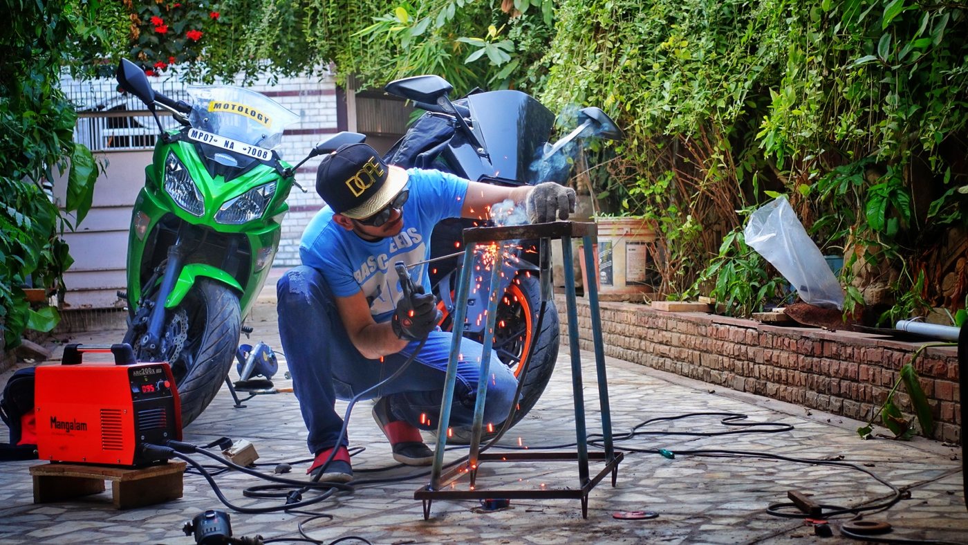A motorcycle being worked on in the Motology garden area